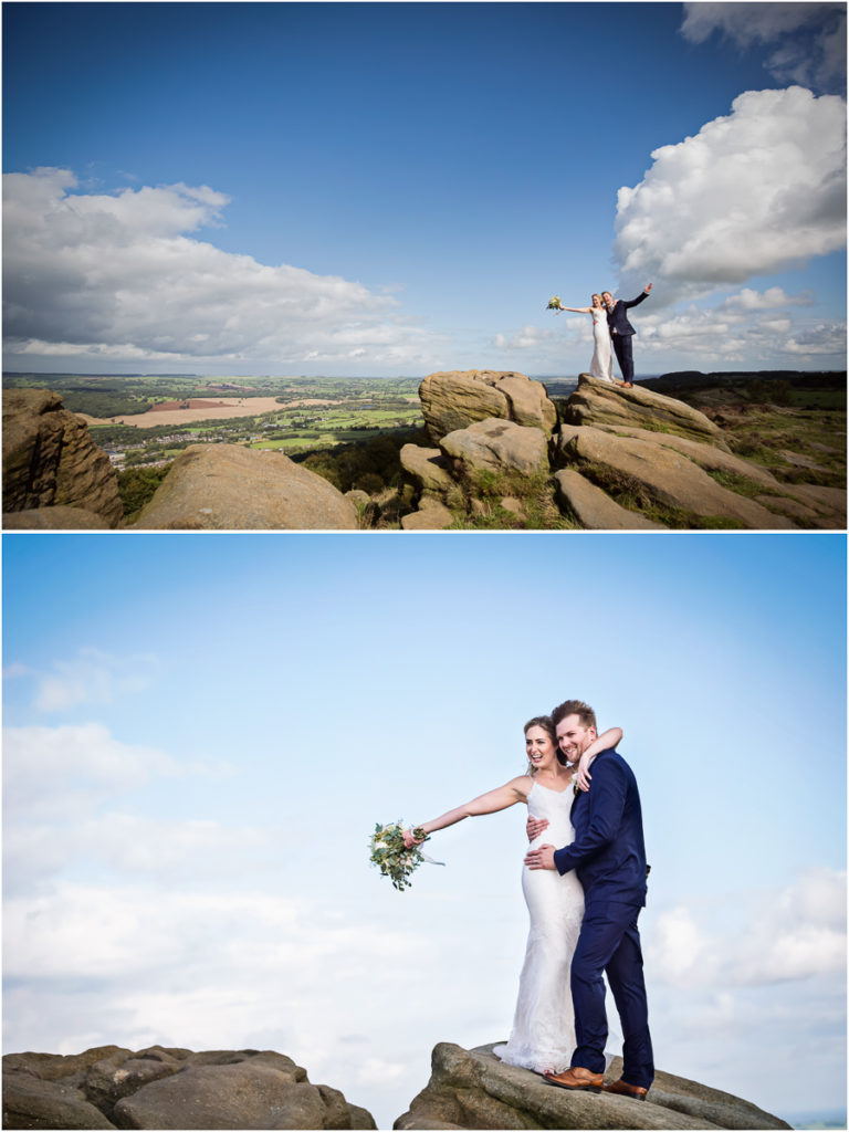 A couple in wedding attire celebrating on a rocky outcrop under a vast sky, with scenic views in the background.