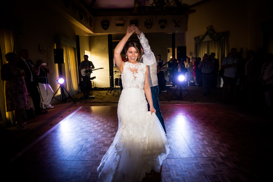 Bride dancing joyfully on the dance floor at a wedding reception.