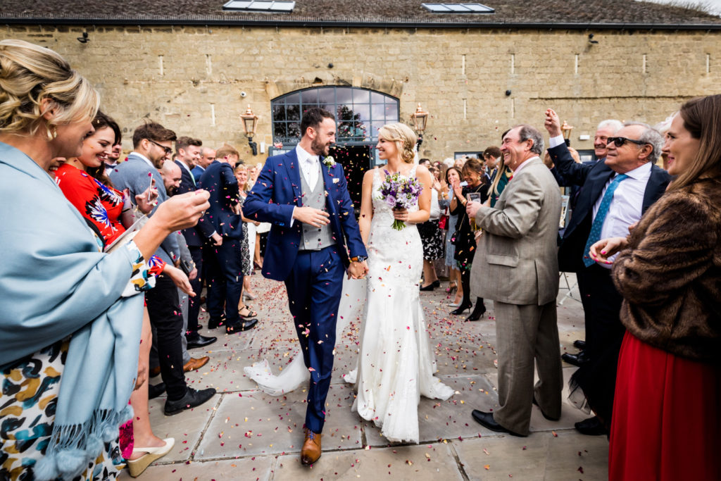 guests showering the couple with confetti at Wharfedale Grange
