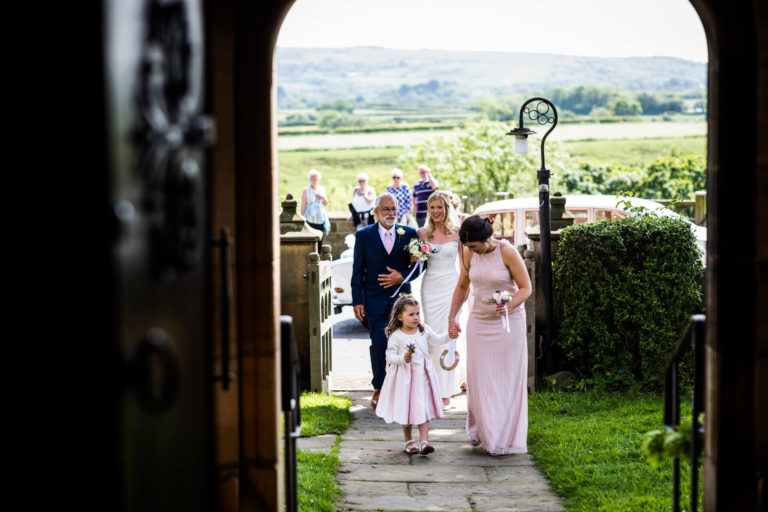 A bride and groom walking down the aisle at a wedding ceremony.