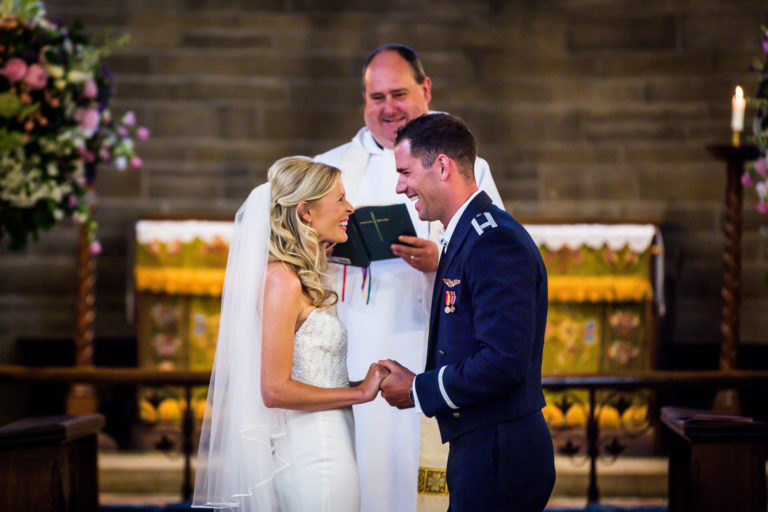 A bride and groom exchange vows in a wedding ceremony in a church.