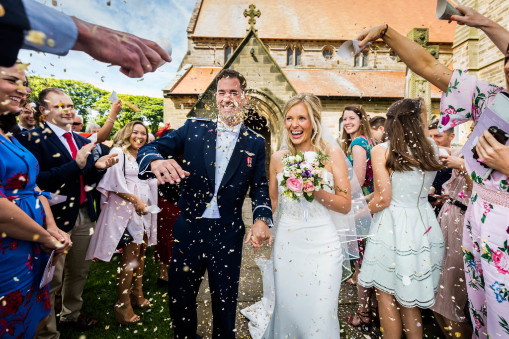 Wedding couple being showered with confetti at Robin Hoods Bay