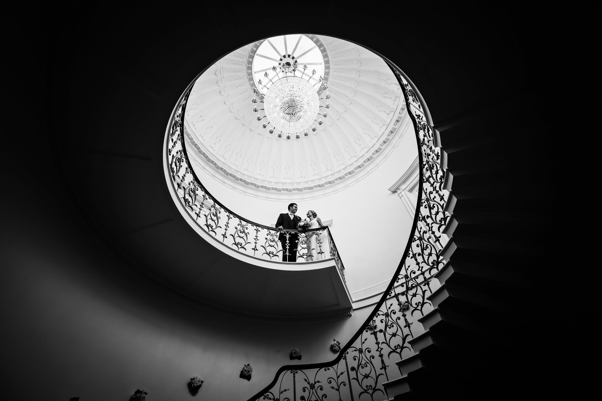 bride and groom at the top of a staircase at Denton Hall
