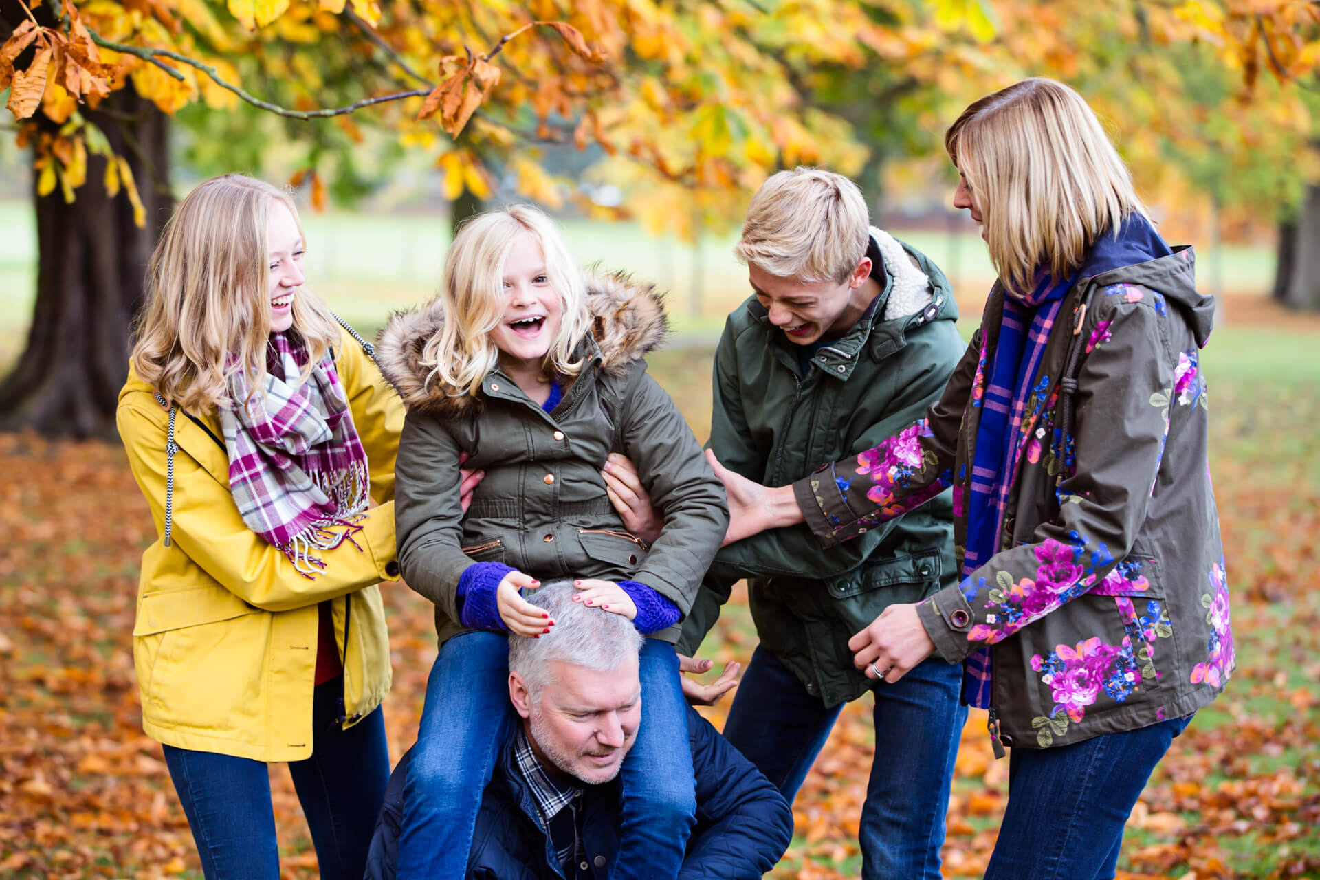 family laughing together in a harrogate park