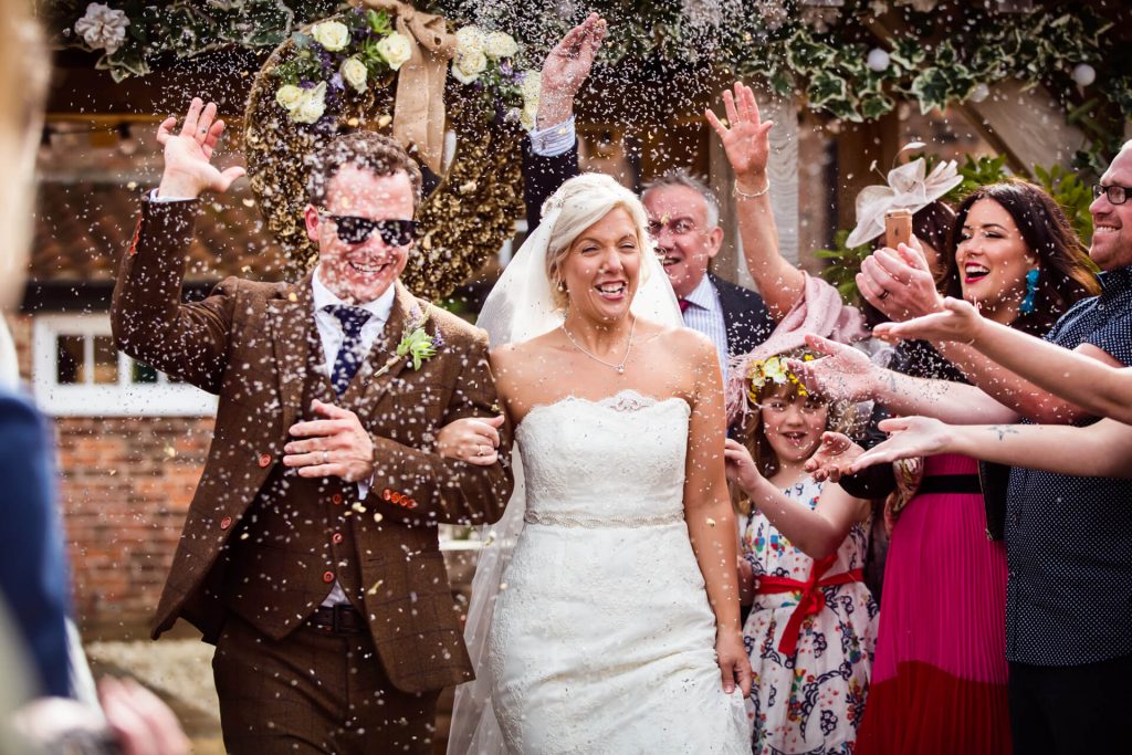 bride and groom showered with confetti at Hornington Manor