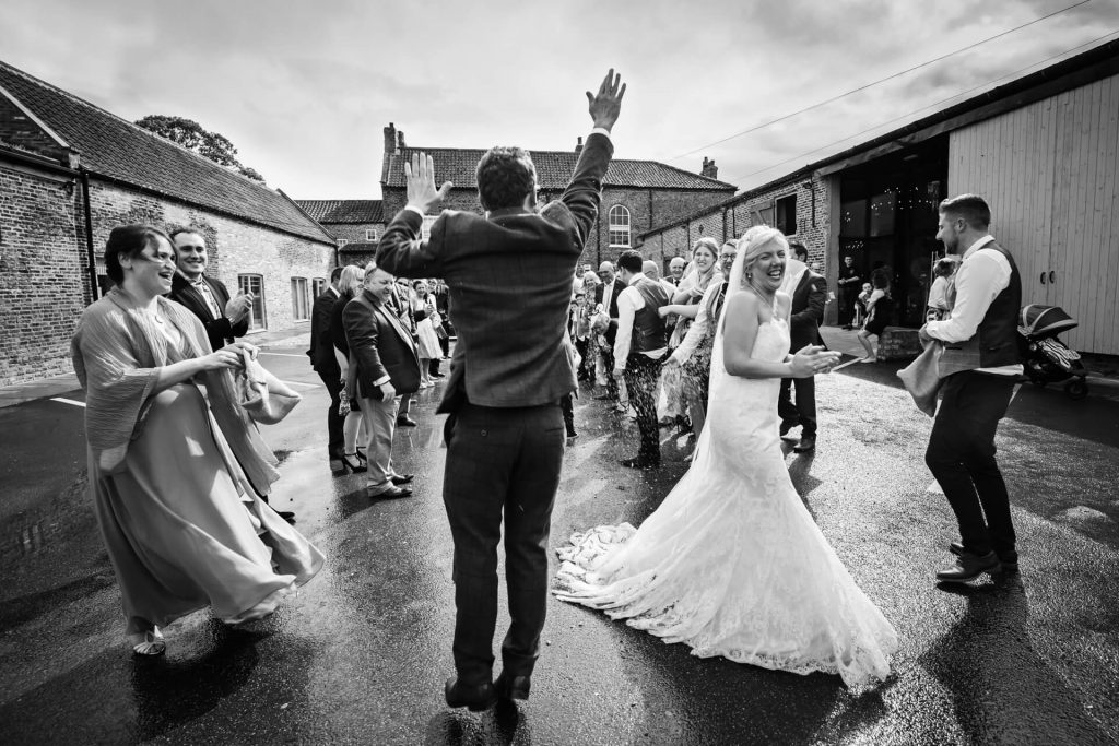 Groom jumping in the air at Hornington Manor