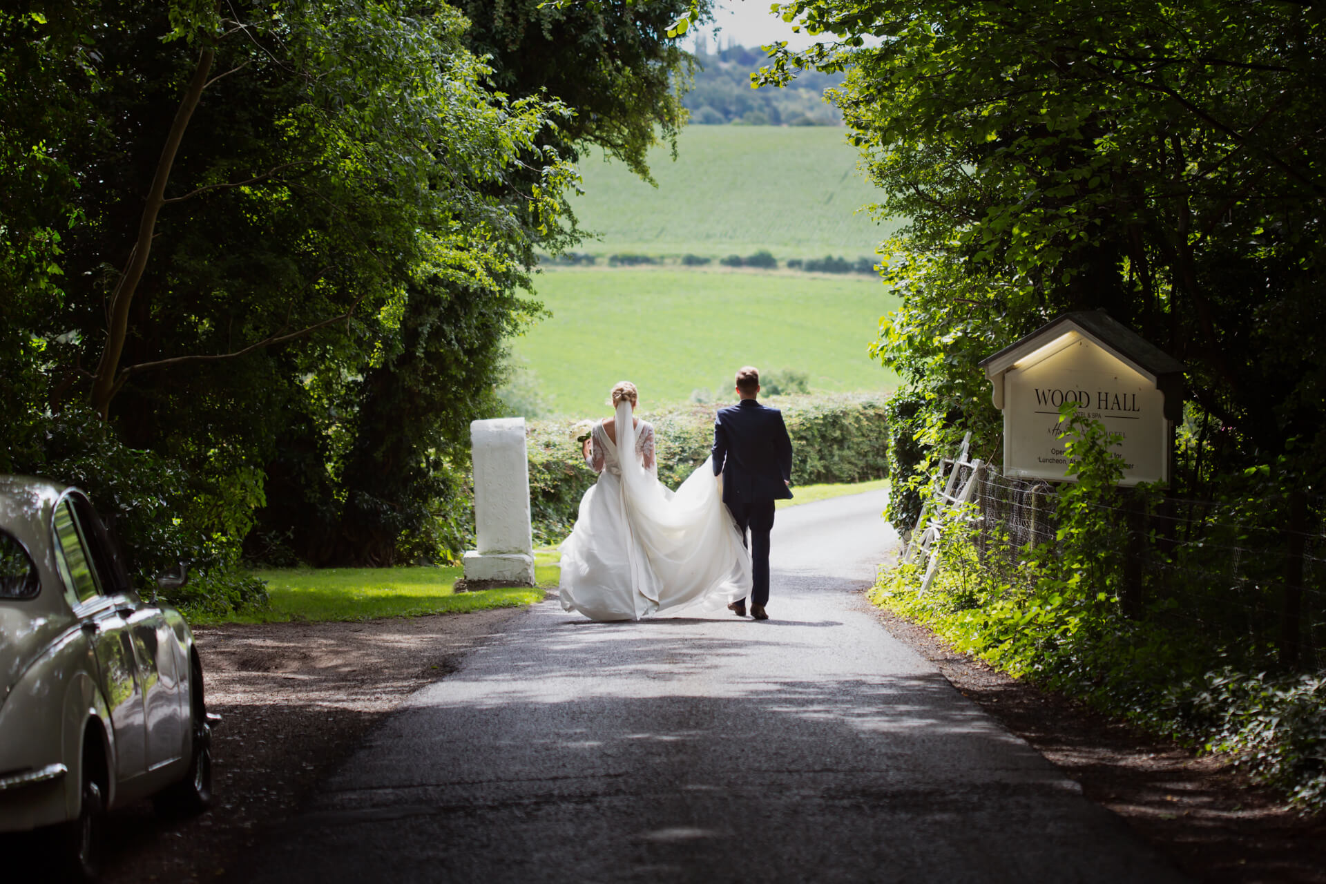 Wood Hall Hotel Wedding Photography - Couple walking towards Wood Hall