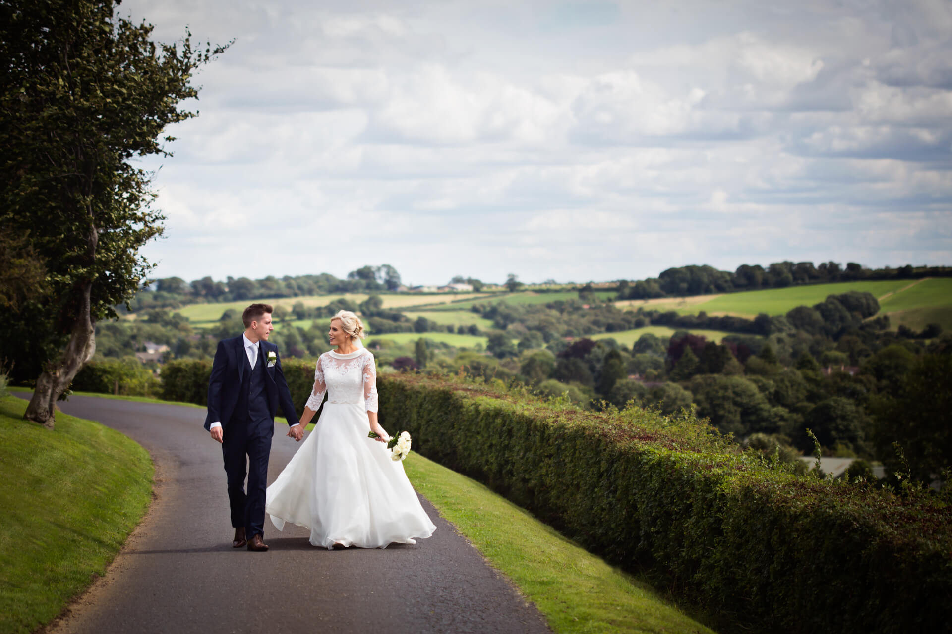 Wood Hall Hotel Wedding Photography - couple walking along the lane above the venue