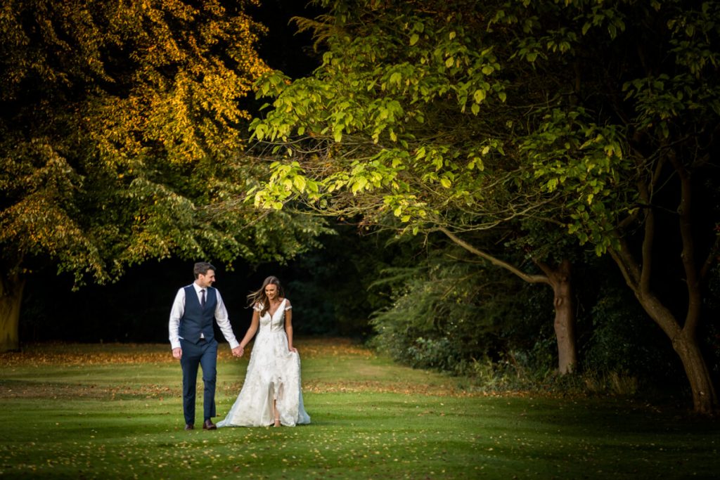 couple walking through the gardens at Saltmarshe Hall
