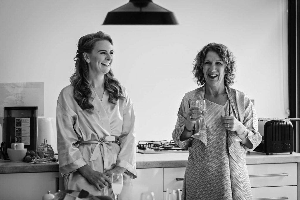 bride and mother laughing