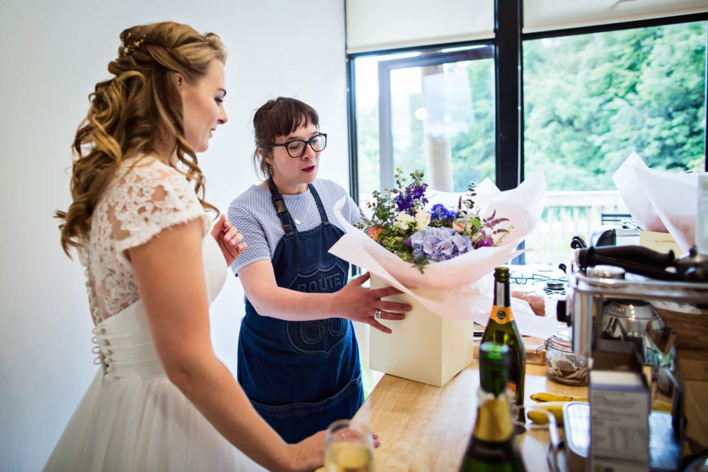 bride receives her flowers from the florist
