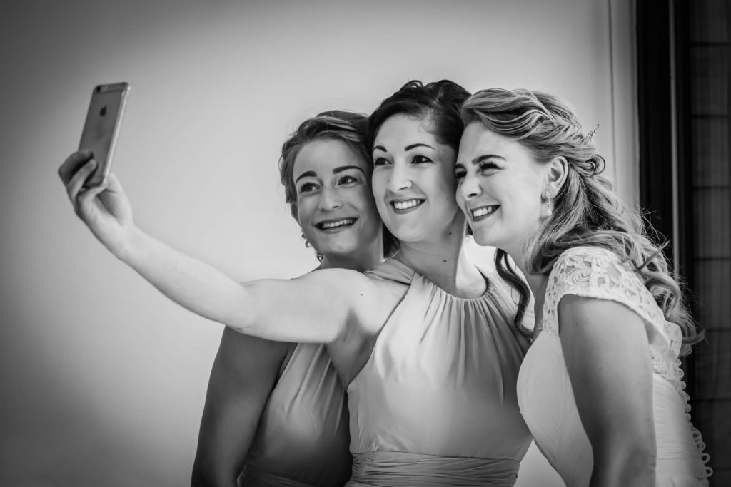 bridesmaids and bride taking a selfie