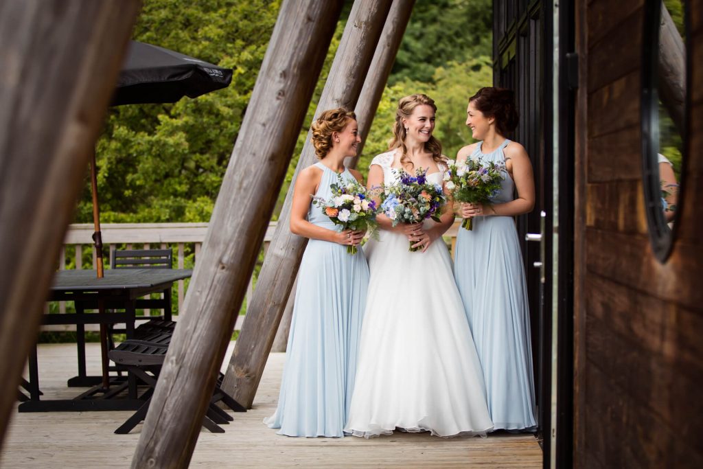portrait of the bride and bridesmaids outside the cabin at Natural Retreats