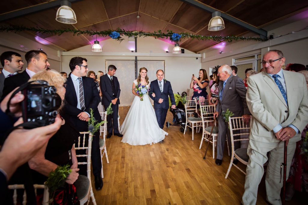 A yorkshire dales wedding ceremony - bride walks the aisle with her Dad
