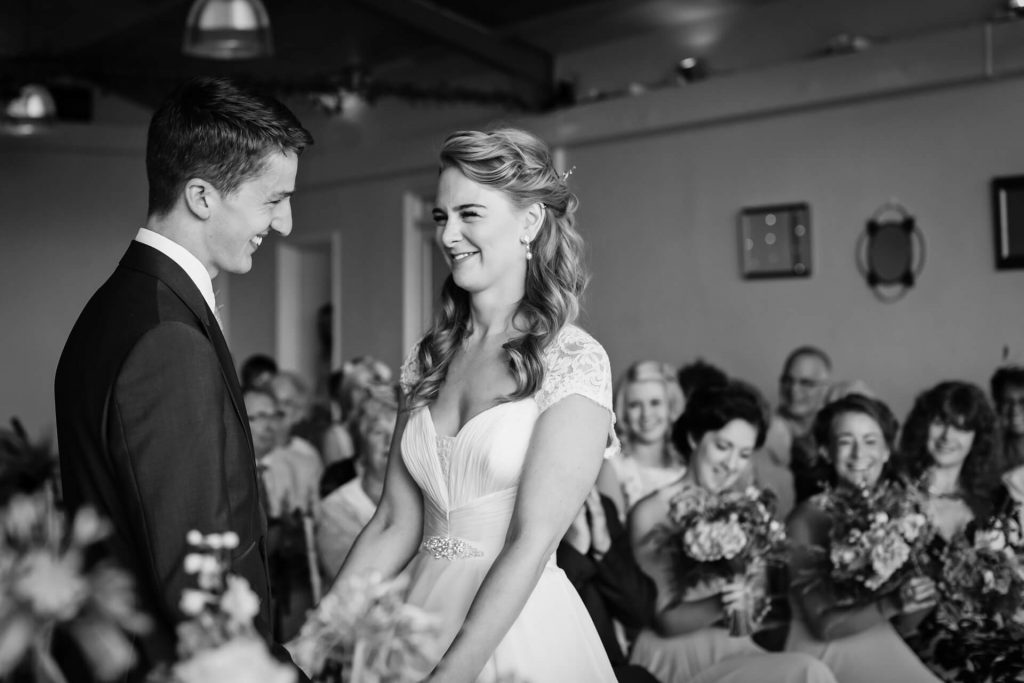 couple smiling at each other during the wedding ceremony