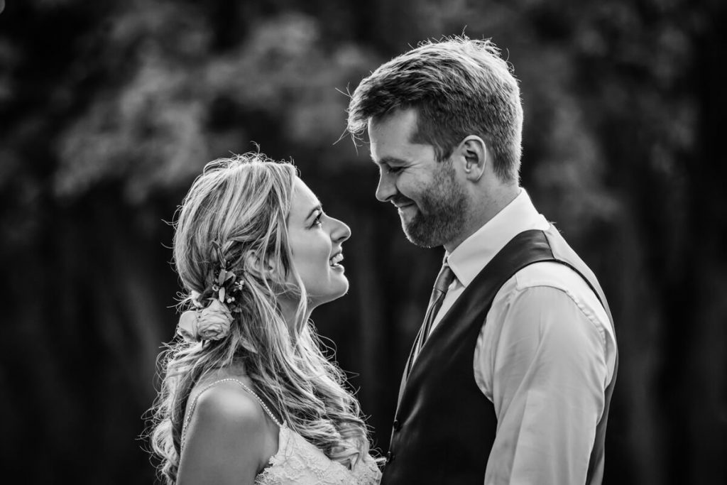 bride and groom smiling at each other
