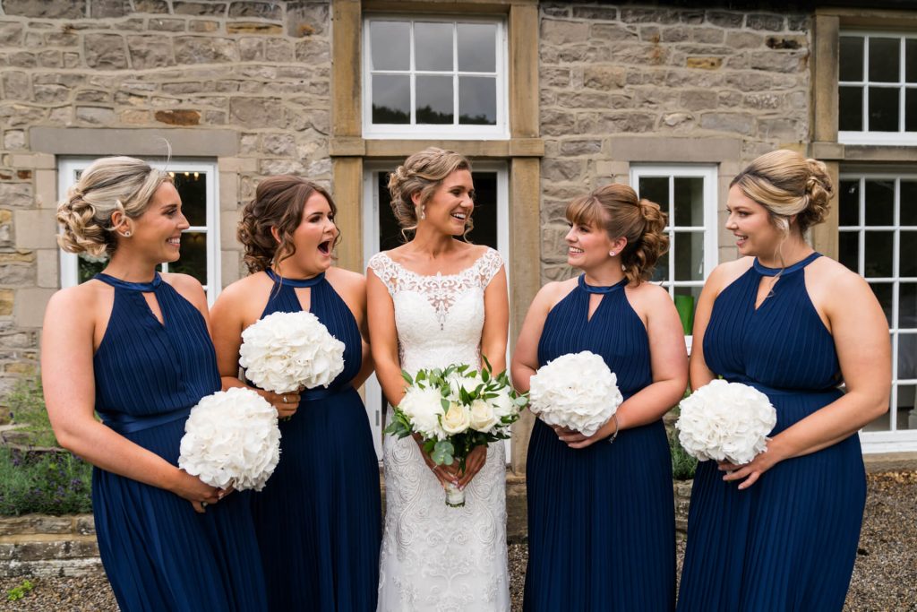 bride and bridesmaids standing together