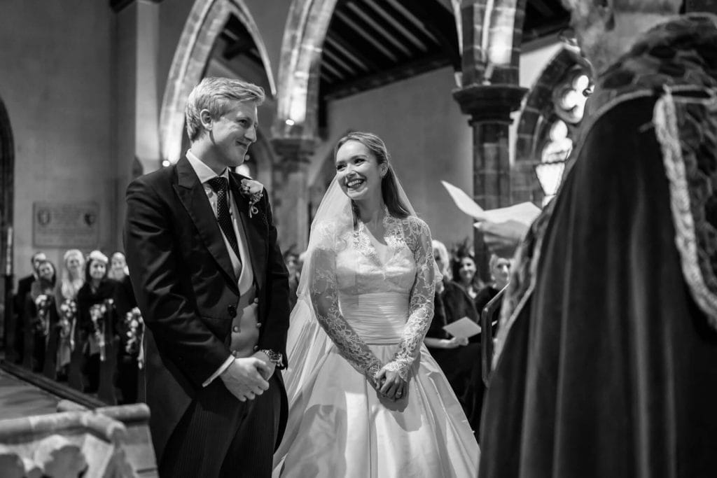 bride smiles at the groom inside Goldsborough church