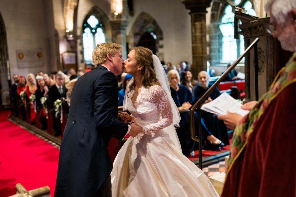 bride and groom kiss in Goldsborough church