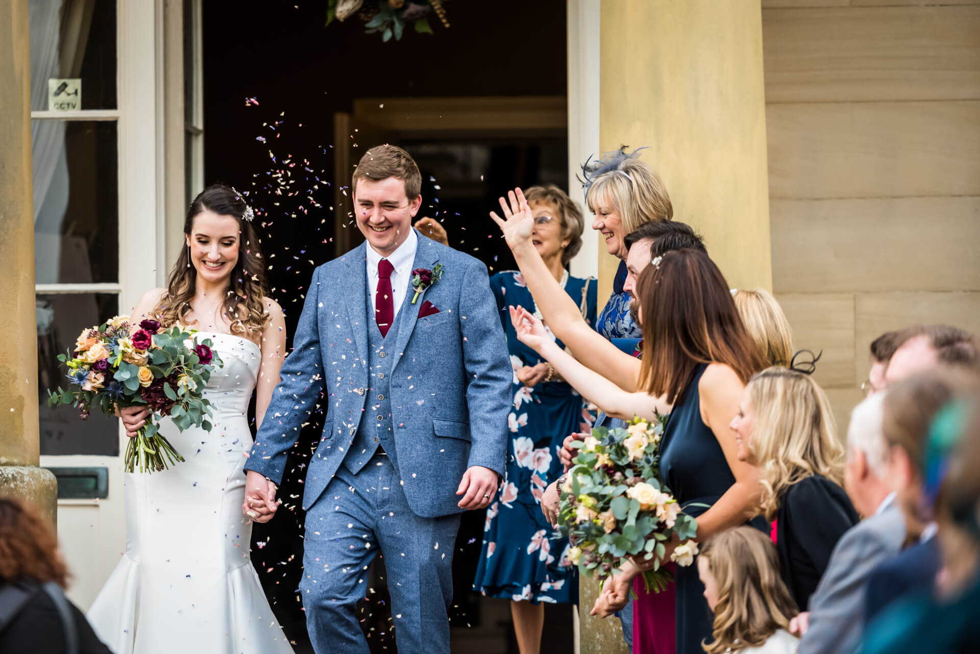 bride and groom are showered with confetti at Saltmarshe Hal