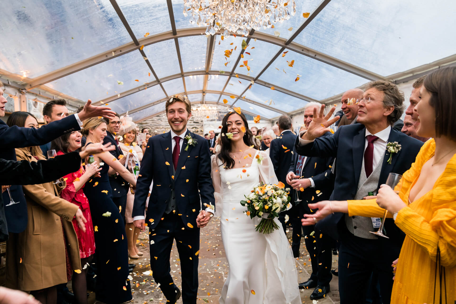 wedding guests through confetti over the couple at the town head estate