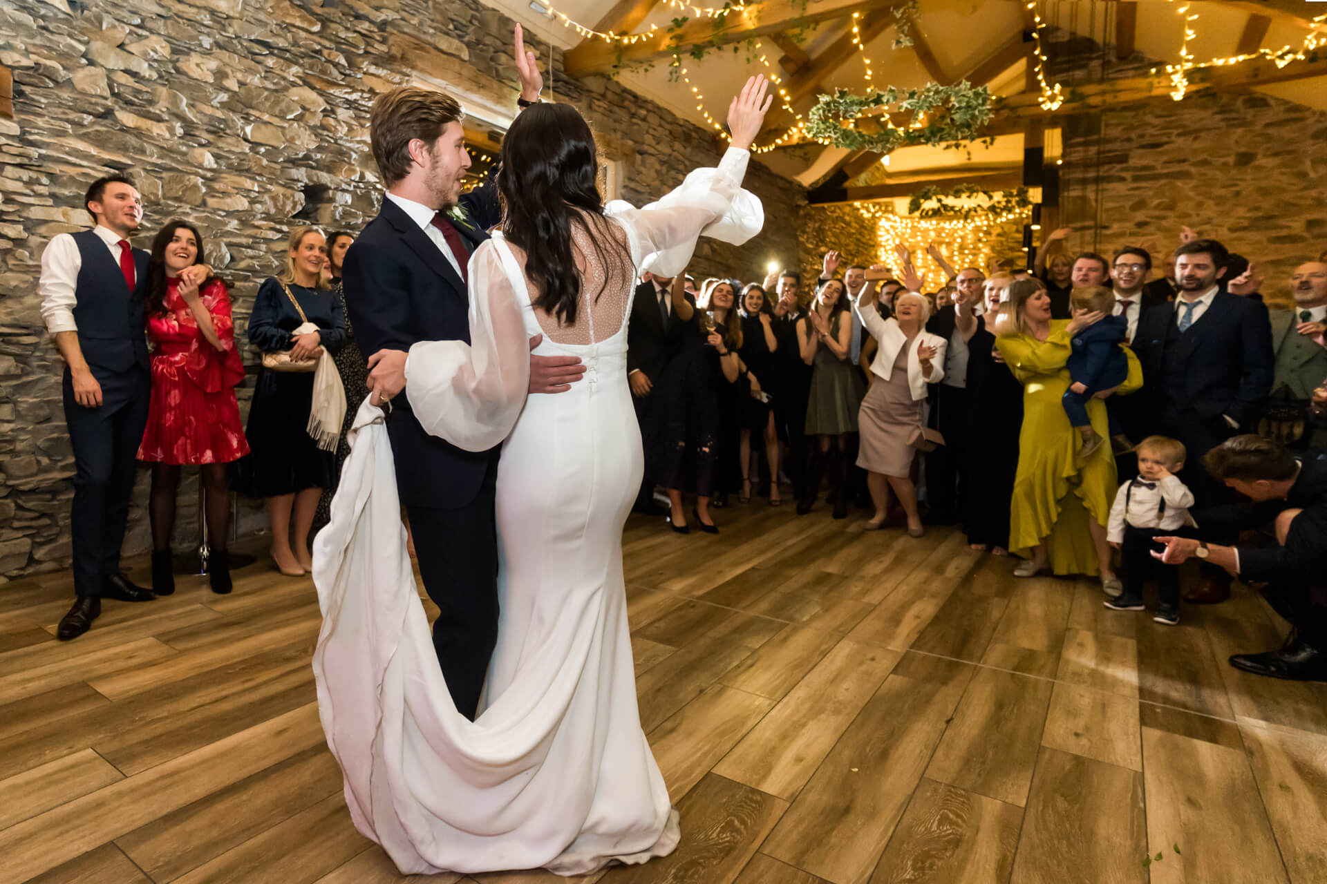 bride and groom call the guests onto the dance floor