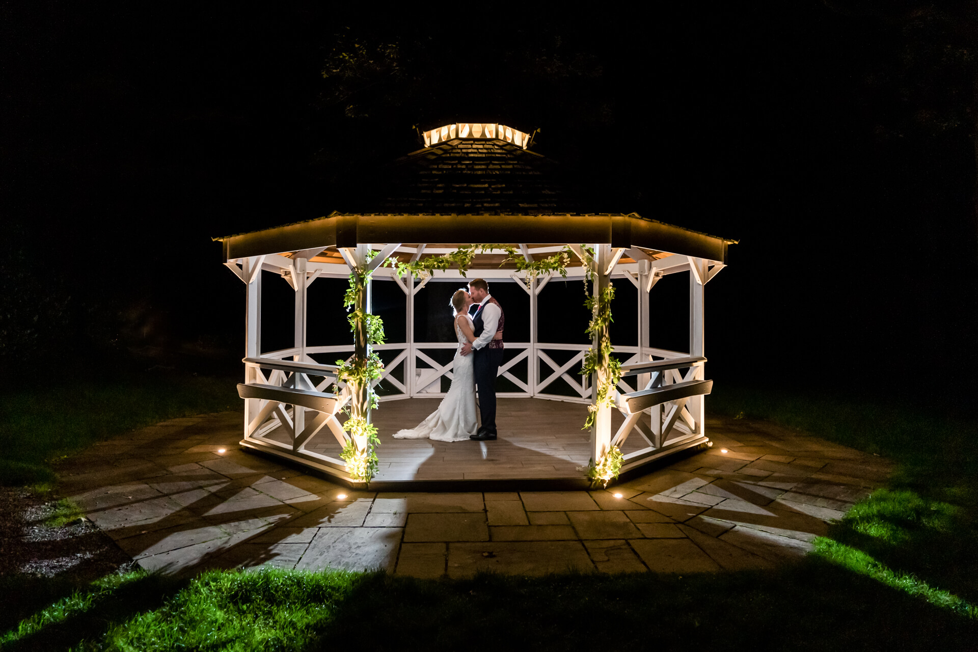 bride and groom kiss in the pagoda at Armathwaite Hall
