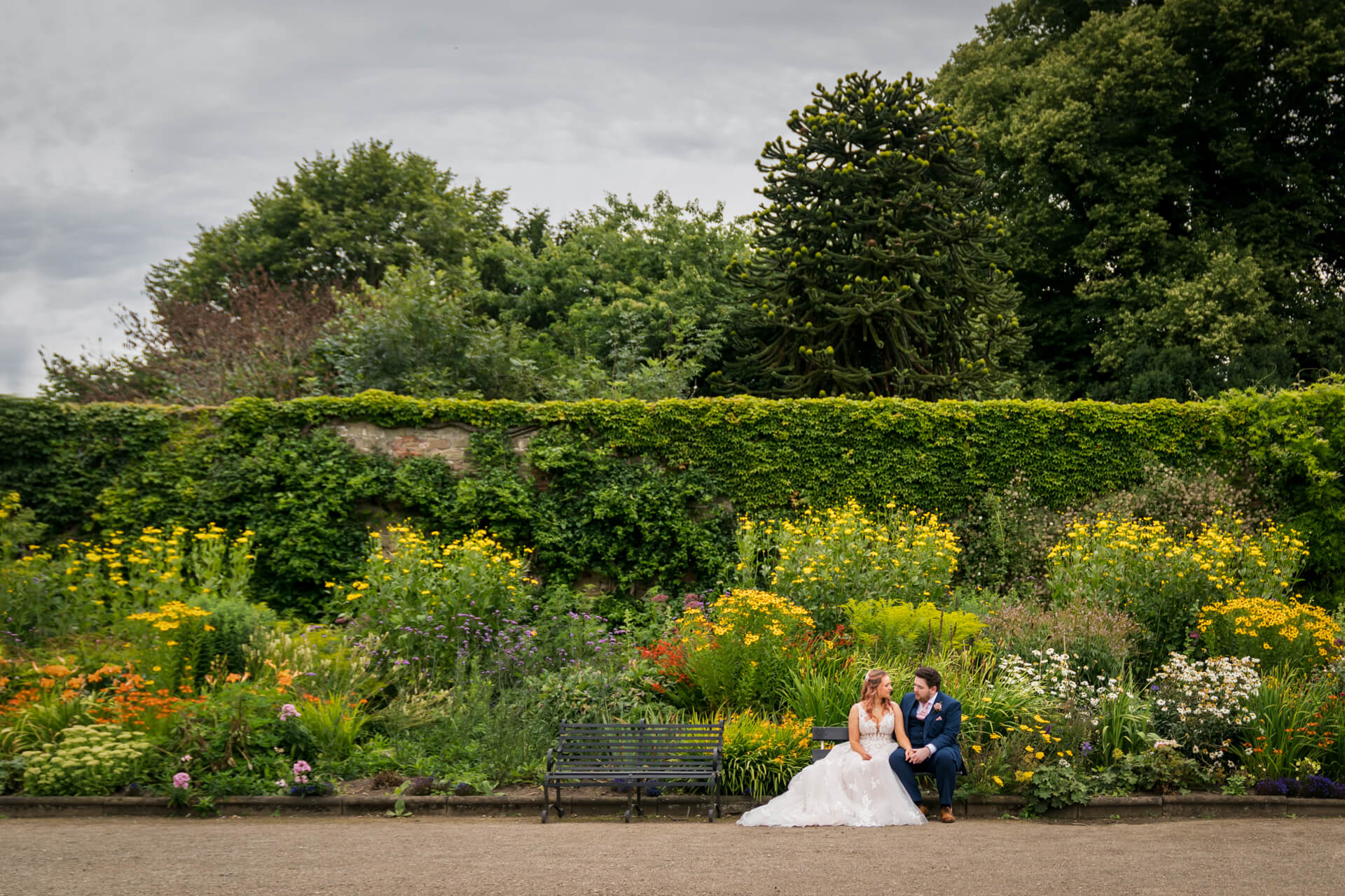Wedding couple sitting in some Harrogate gardens
