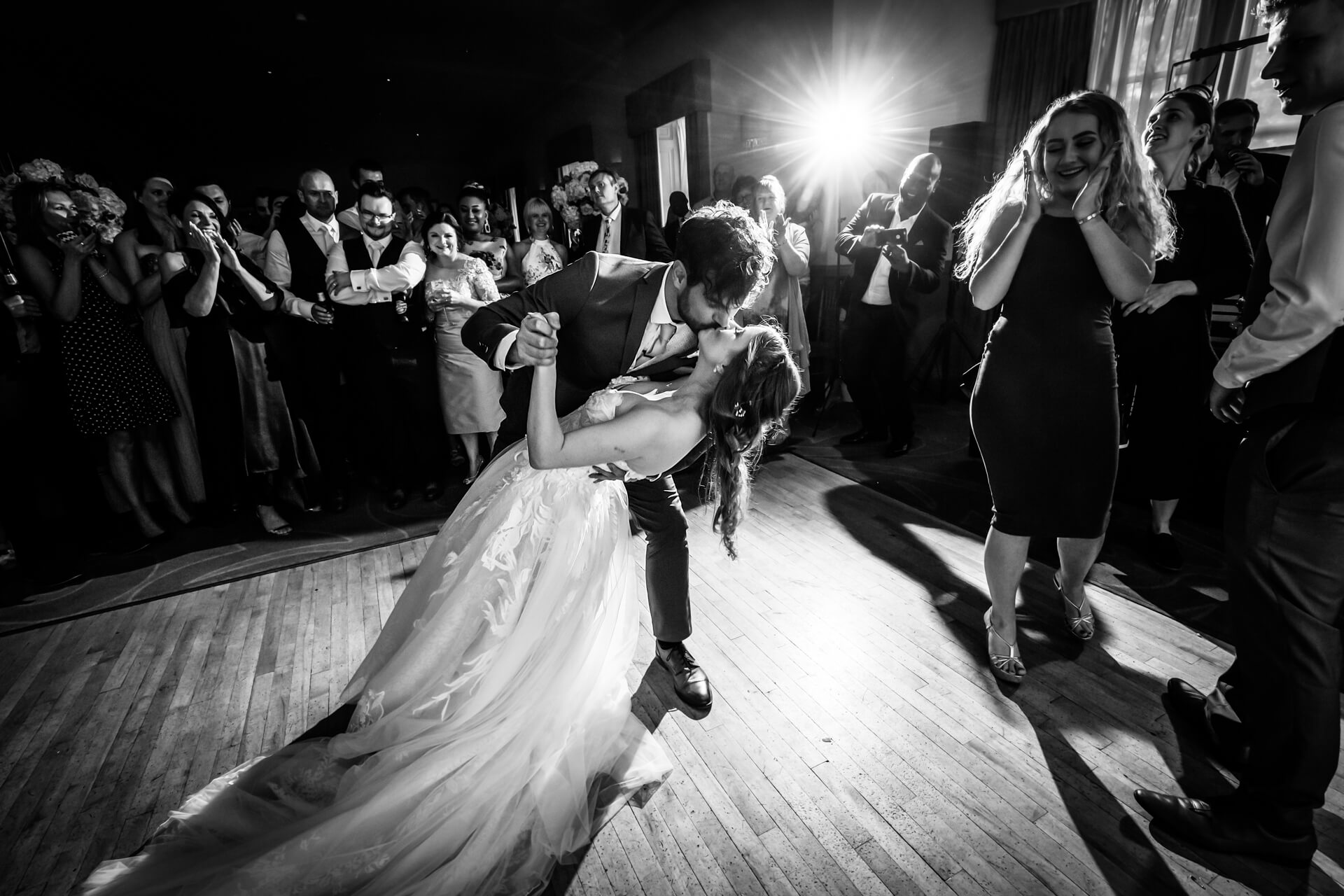 Groom kisses the bride on the dance floor