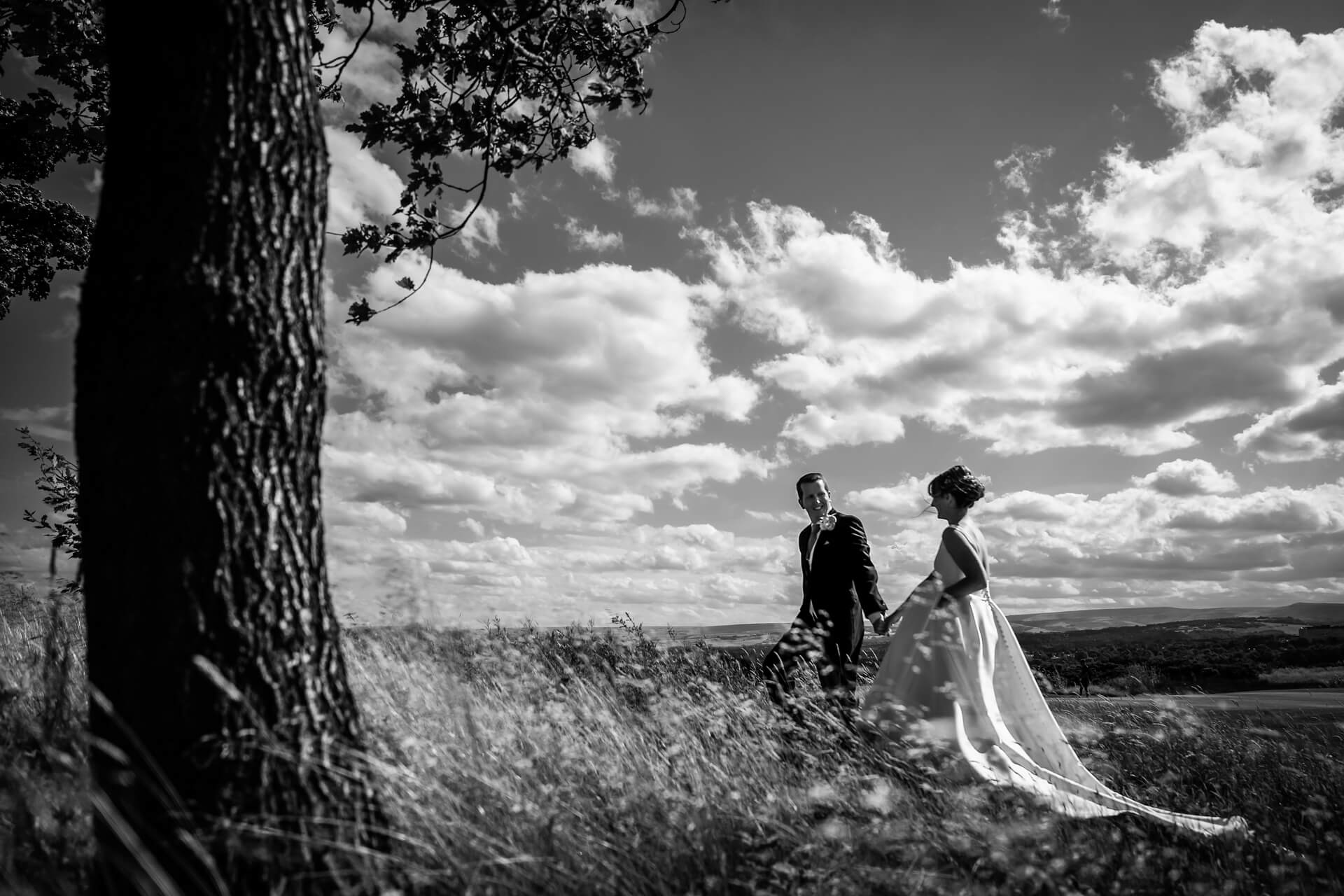 bride and groom walking in the countryside around Leeds