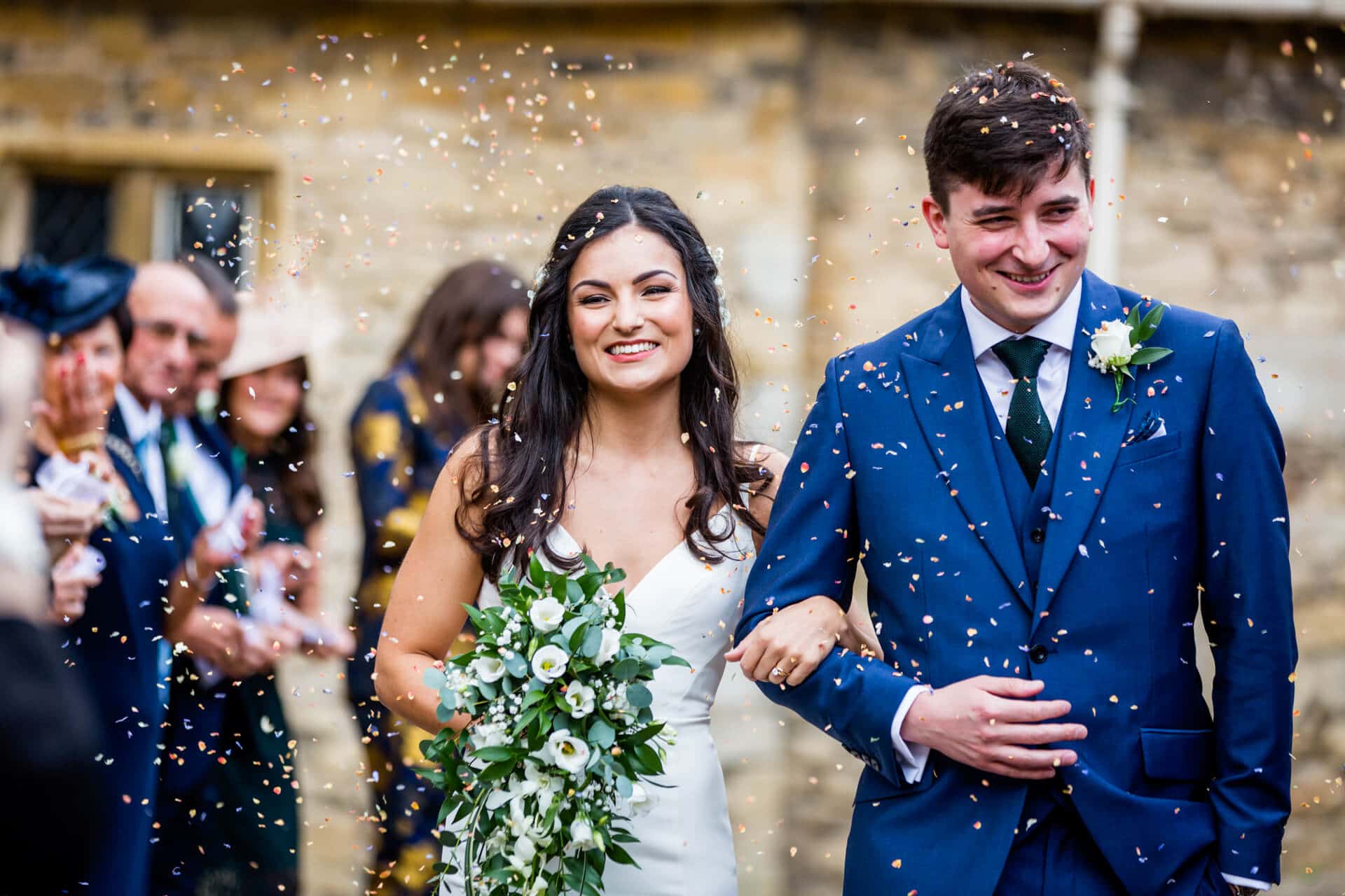 Bride and groom being showered with confetti at Lotherton Hall