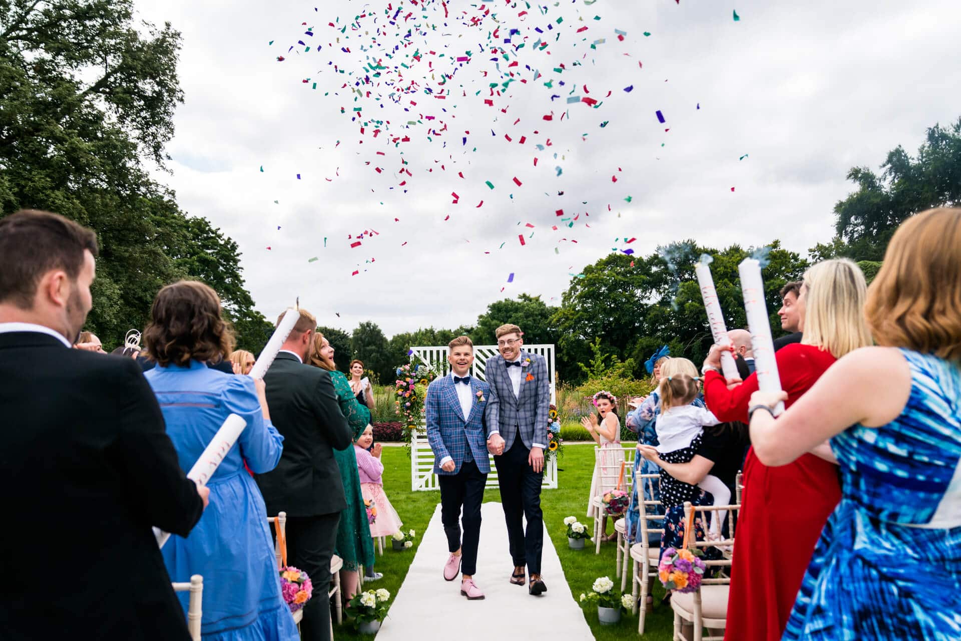 groom and groom under the confetti at Bowcliffe Hall