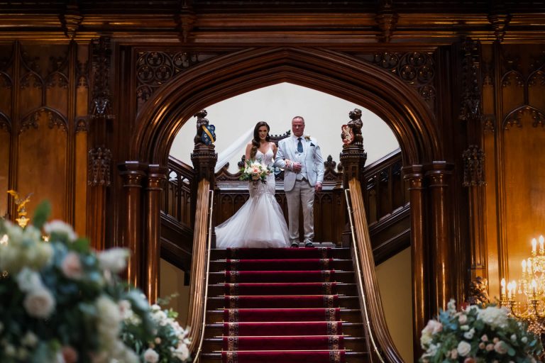 bride and her father about to descend the grand staircase at Allerton castle
