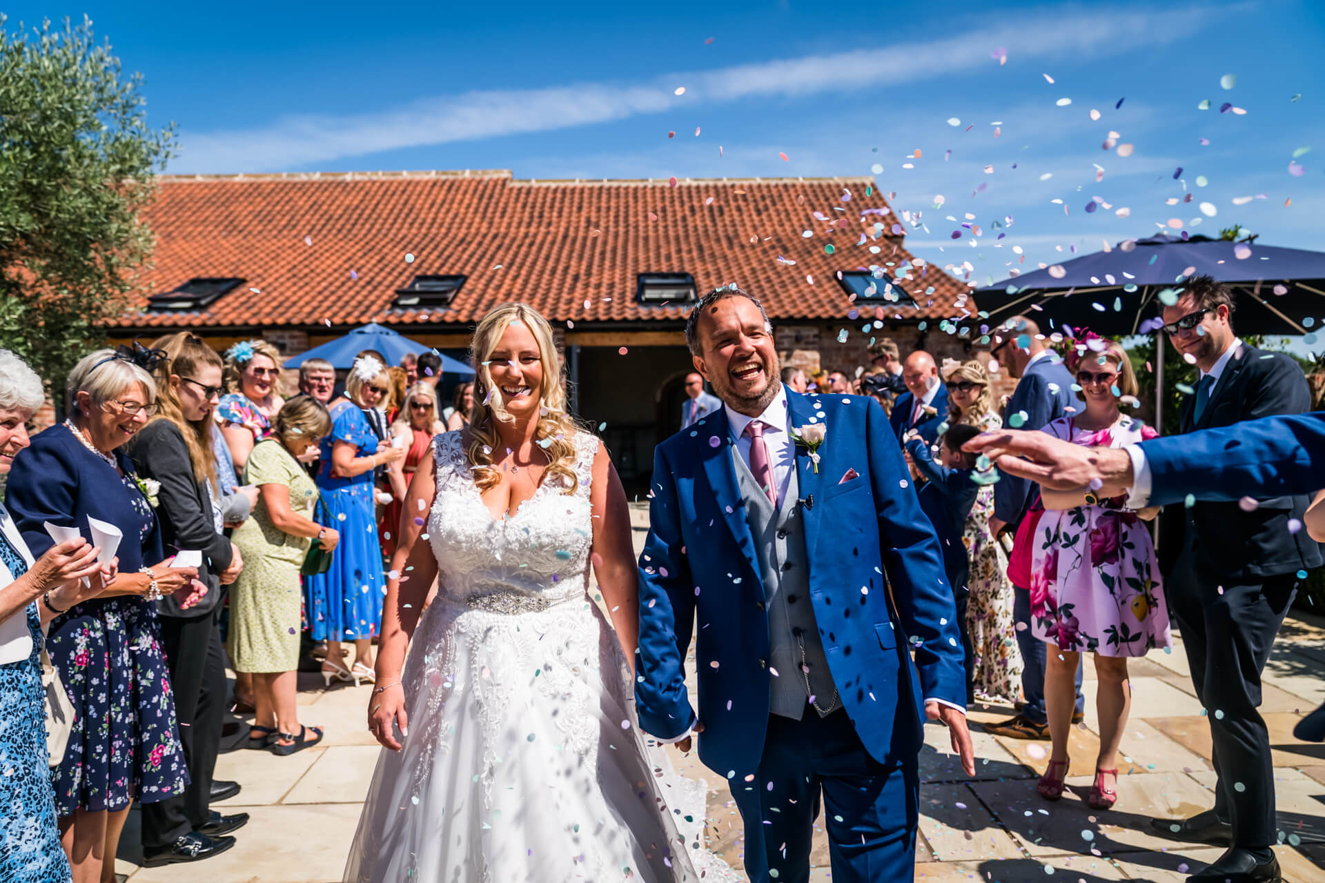 wedding couple being showered with confetti at Thirsk Lodge Barns