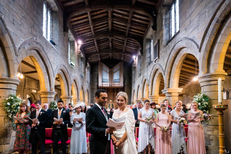 bride and groom singing together in church