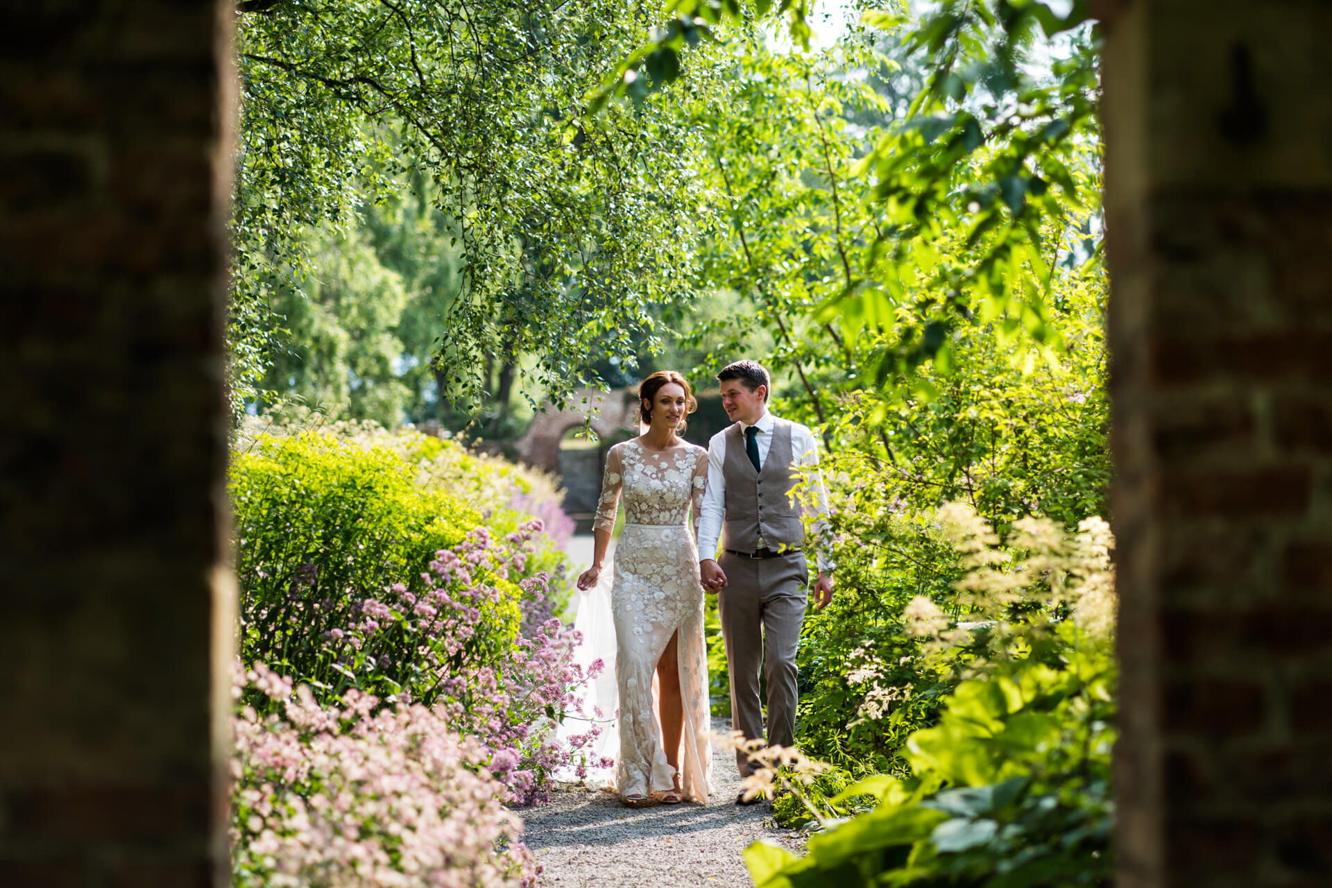 bride and groom walk in the gardens at Middleton Lodge