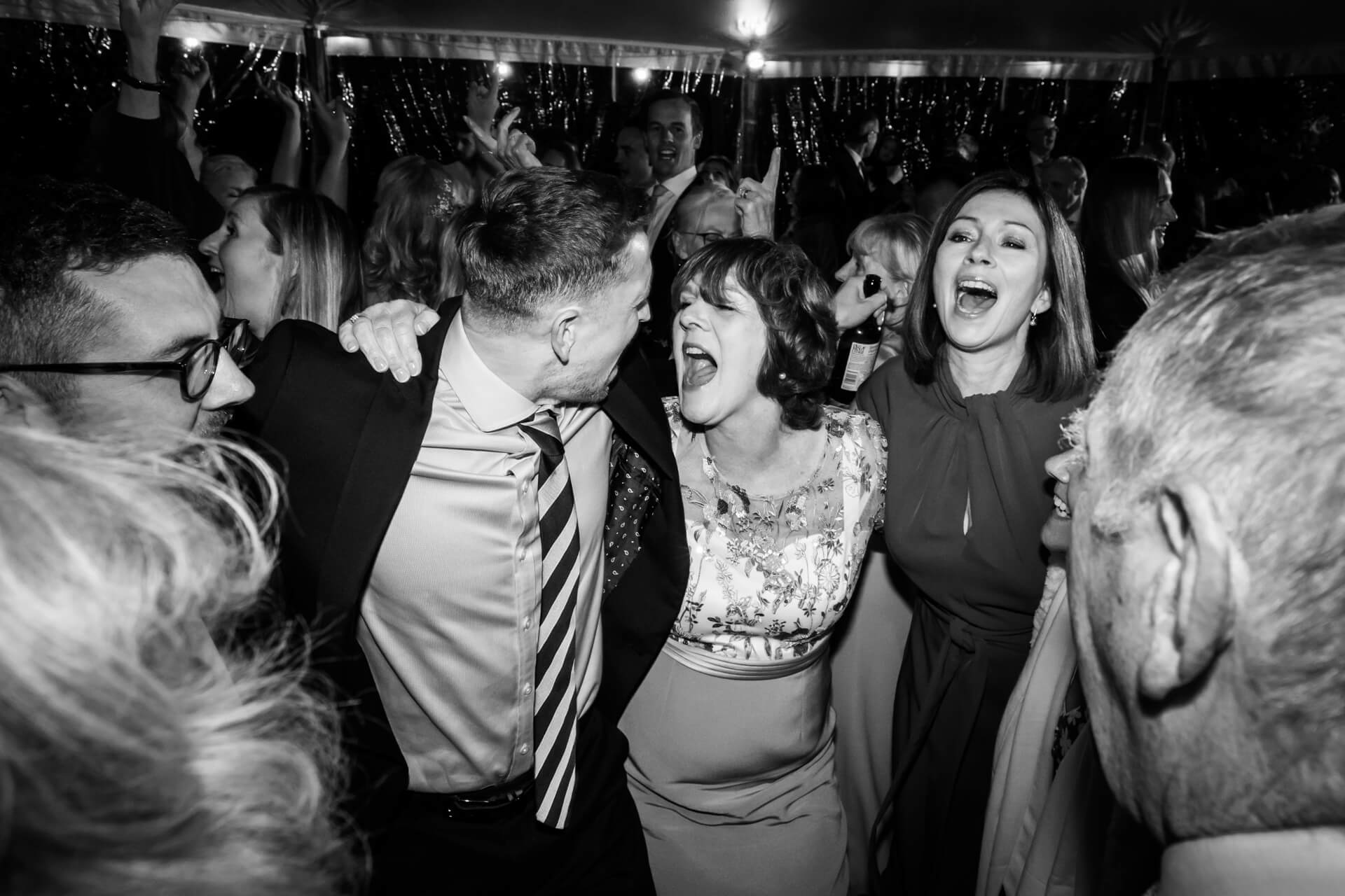 wedding guests laughing and dancing