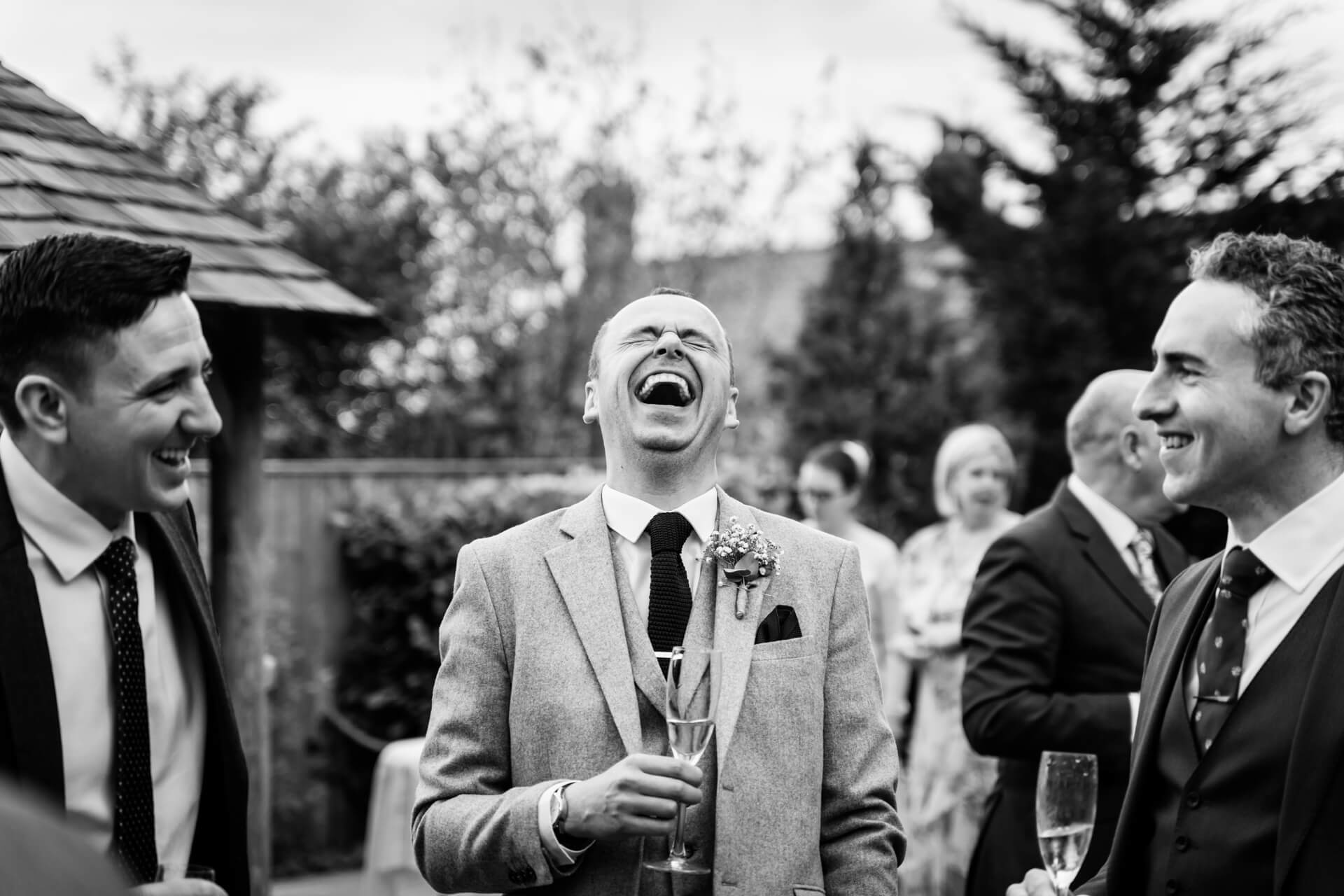 groom laughing with his friends
