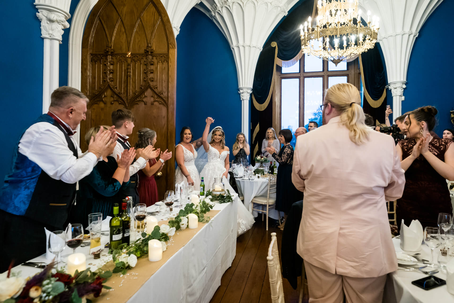 two brides entering the reception to much applause at Allerton castle