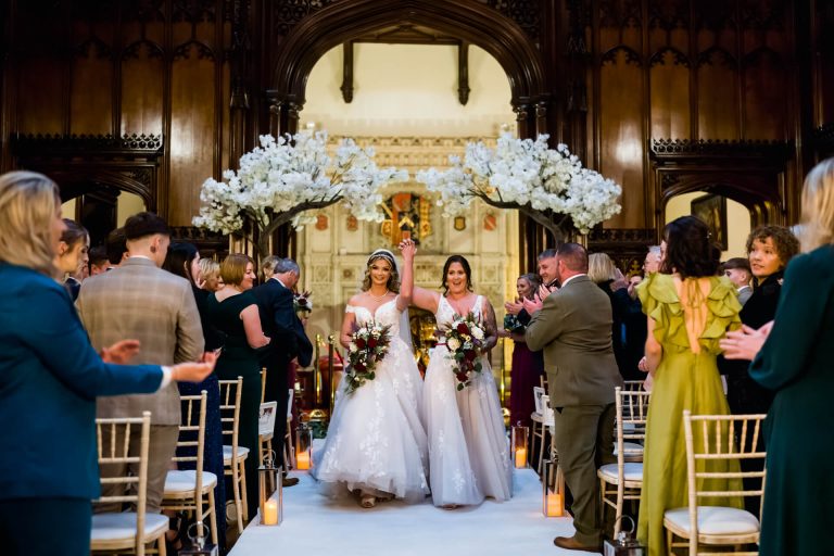 wedding couple walk down the aisle at Allerton castle