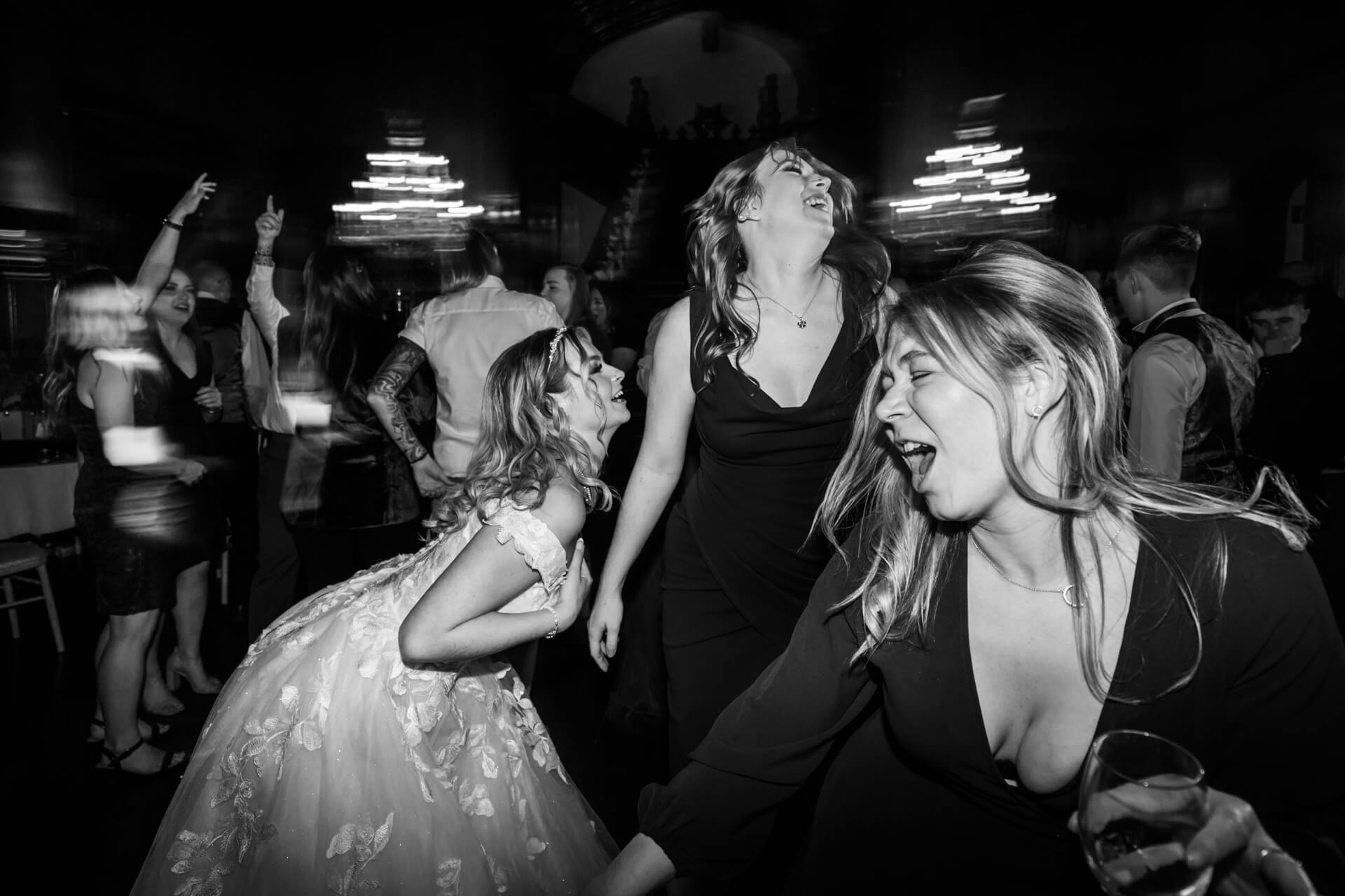 bride and friends dancing