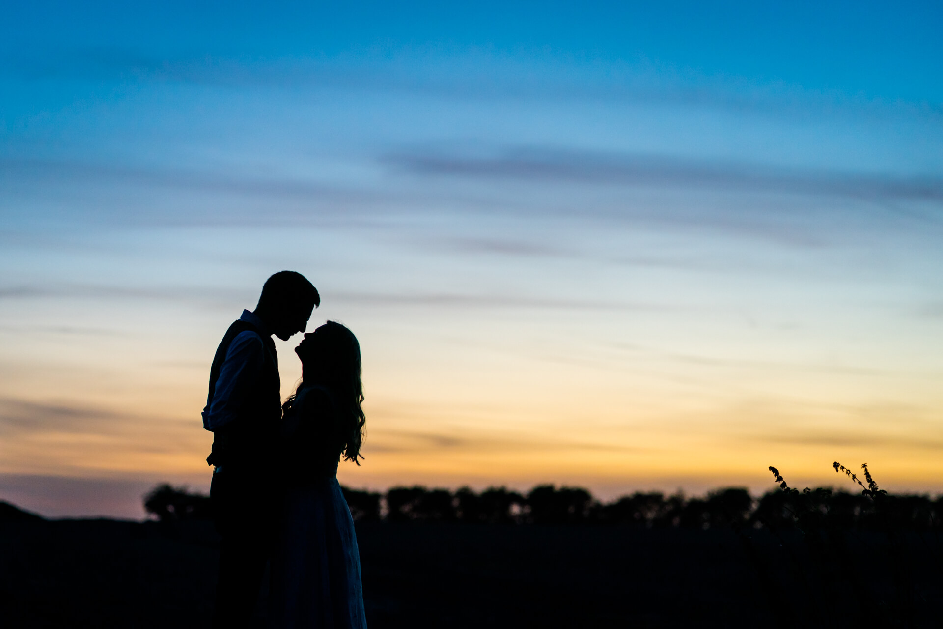 silhouette of wedding couple at sunset