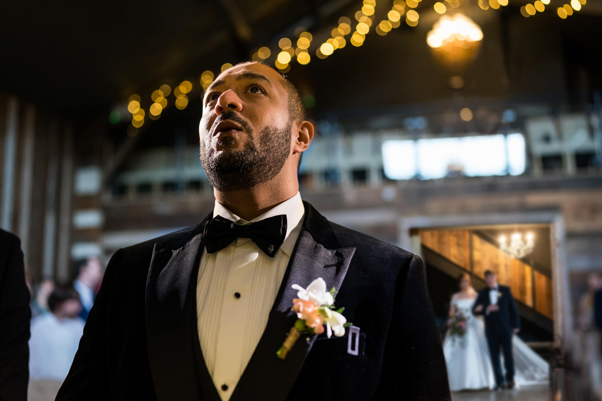 groom waiting for his bride and her dad to walk down the aisle
