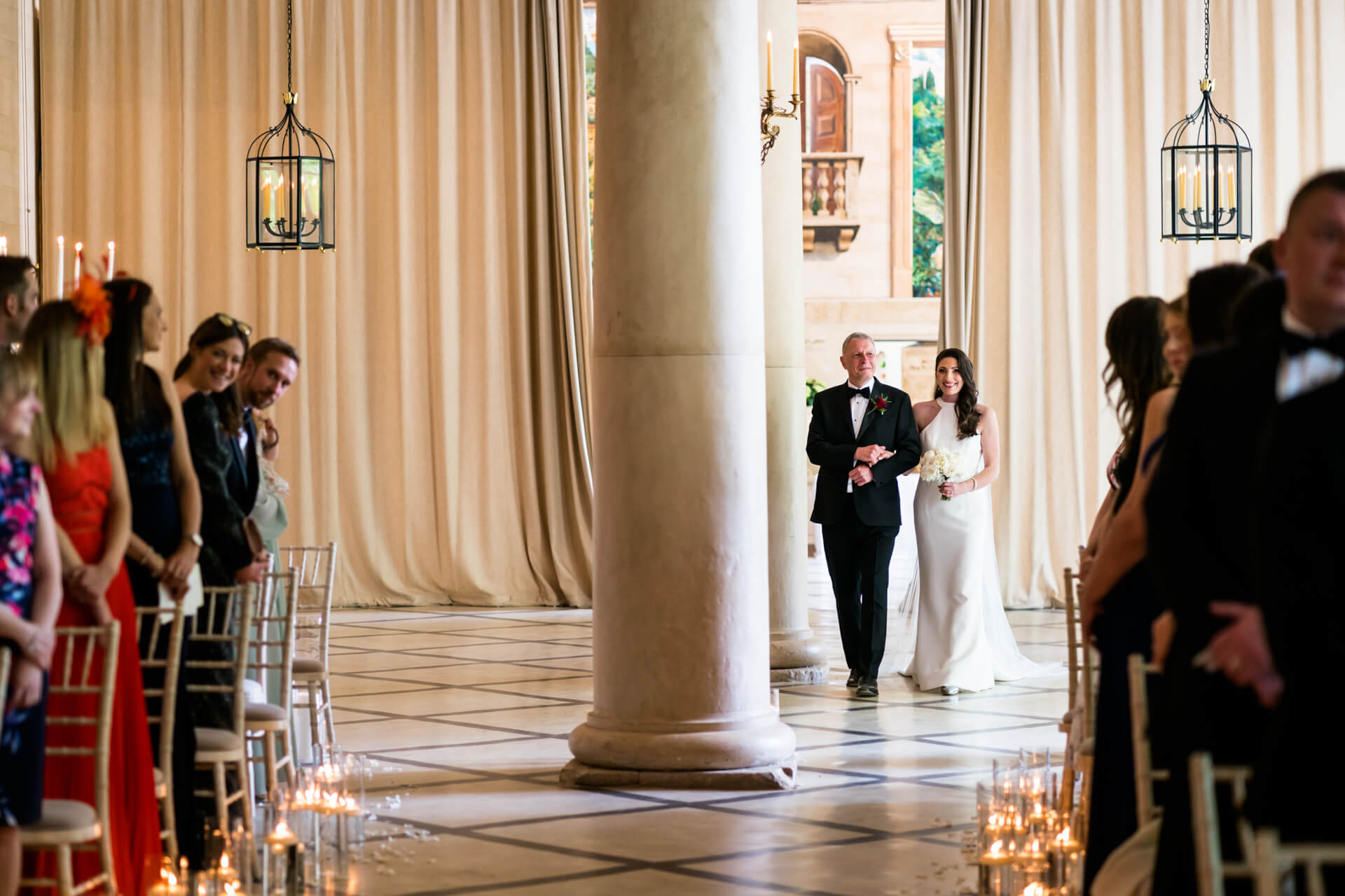 bride and her father walk down the aisle at the Orangery at settrington