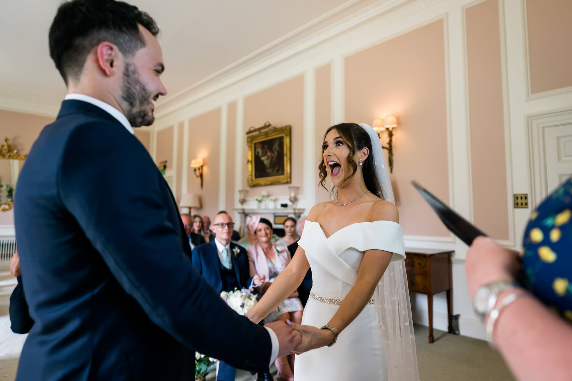 bride shouts with delight as they announce she is married