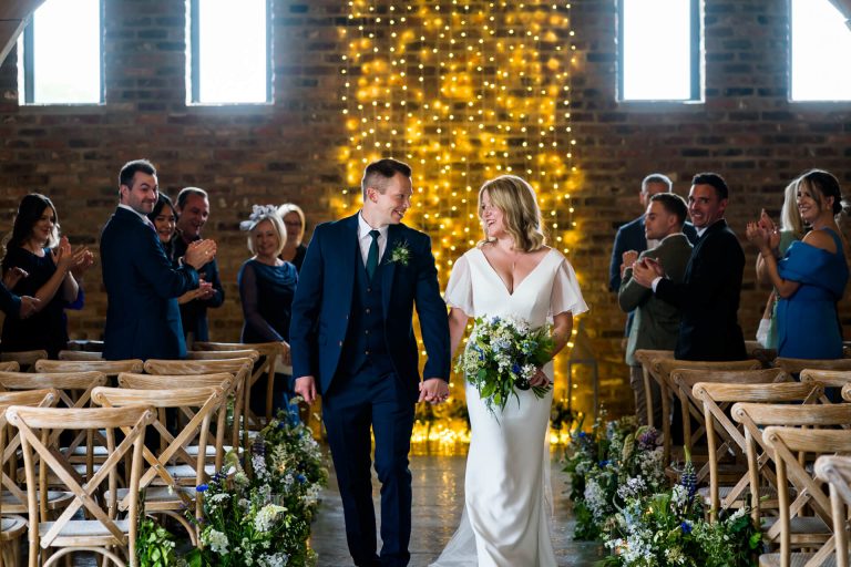 bride and groom walk the aisle at the Oakwood at Ryther