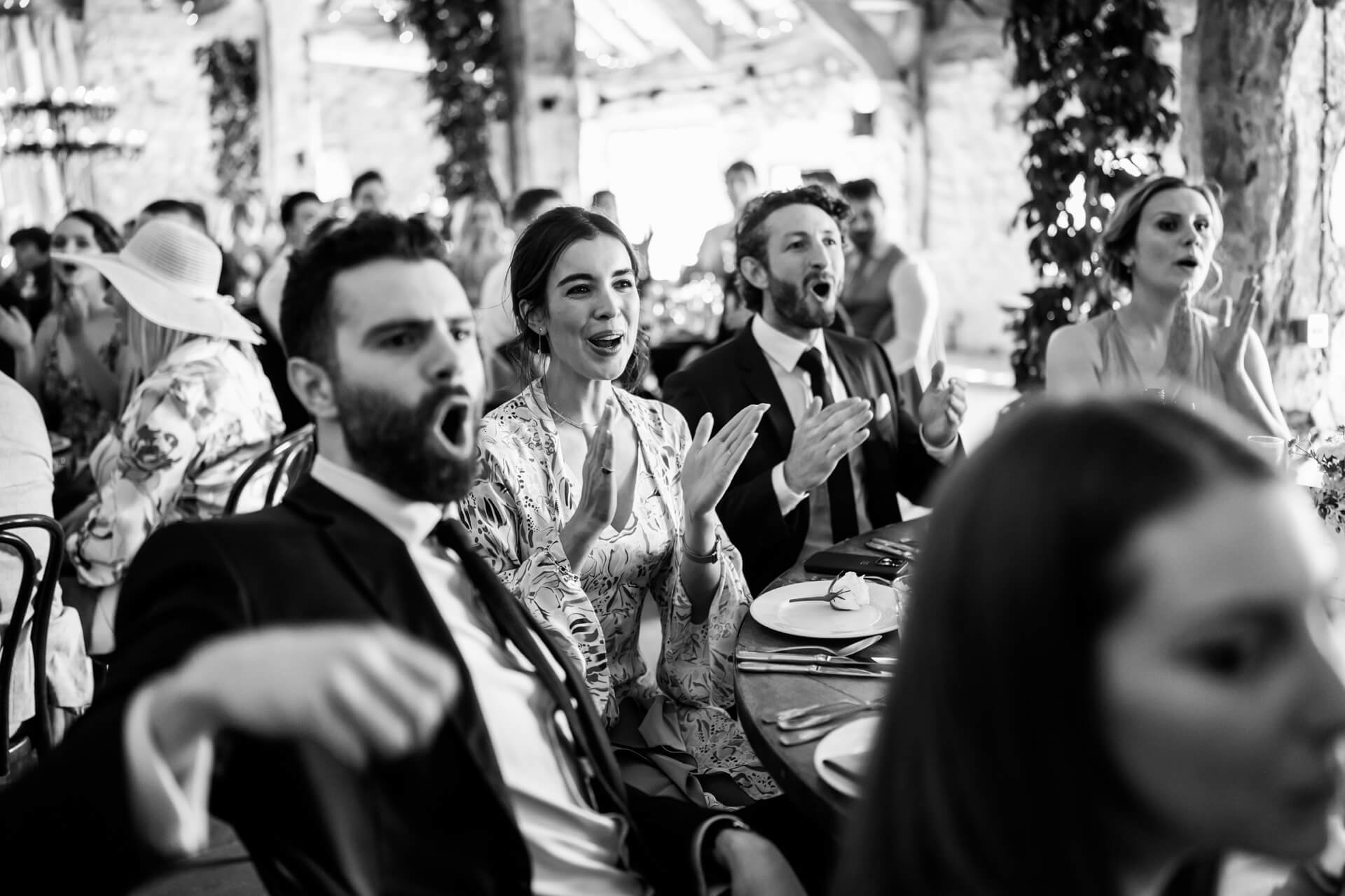 wedding guests clap during the speeches