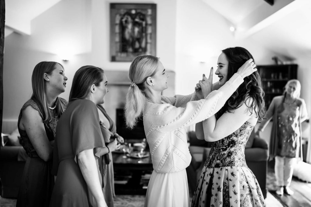 brides friend fixing her hair