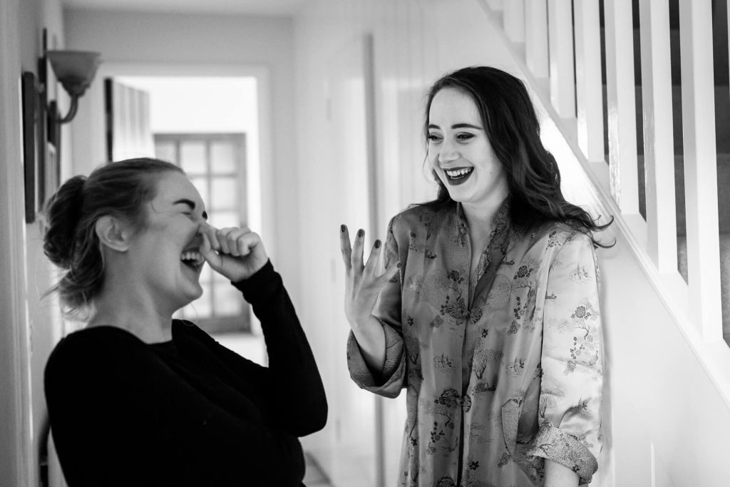 bride and friend laughing together