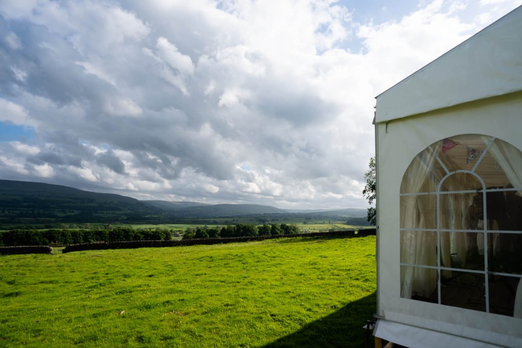 view of Wensleydale in front of the wedding marquee